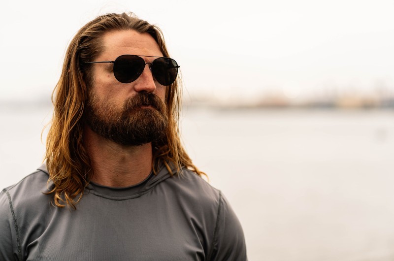 man with long hair wearing polarized sunglasses