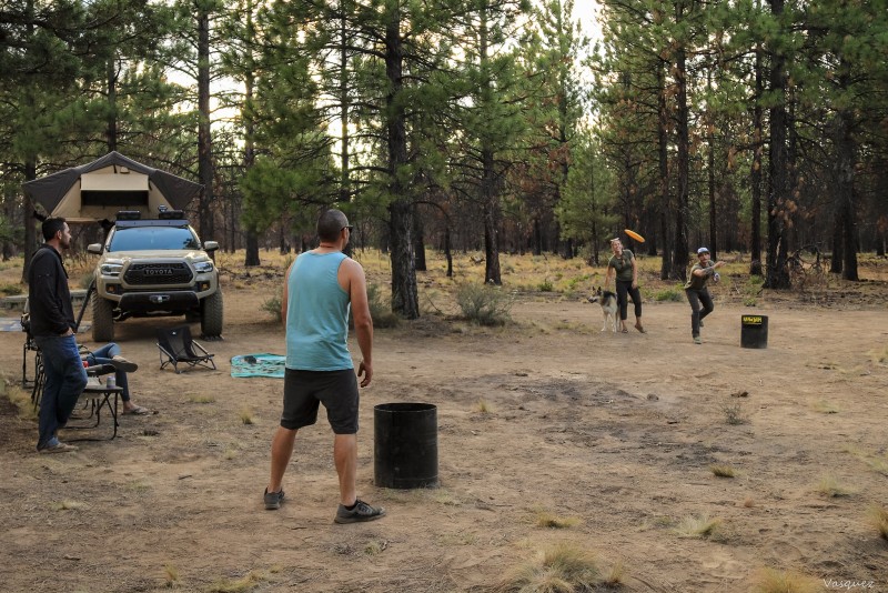 playing frisbee at a campsite