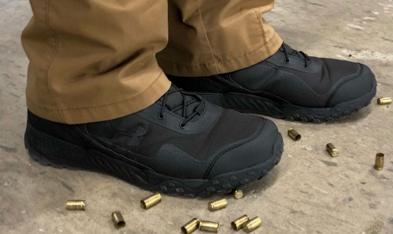 under armour boots surrounded by spent brass